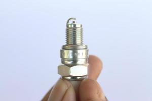 New spark plug in hand before use. photo