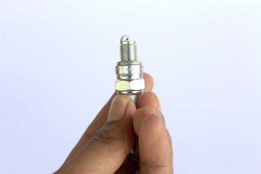 New spark plug in hand before use. photo