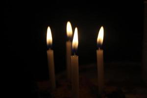 candles burning brightly on black background photo