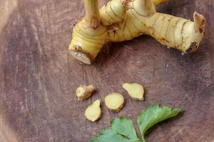Galangal cut into thin strips with celery leaves. photo