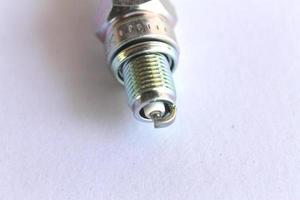 New spark plug in hand before use. photo