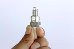 New spark plug in hand before use. photo