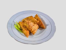 Tempe mendoan Triangular fried tempeh wrapped in wheat flour produces a savory taste photo