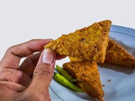 Tempe mendoan Triangular fried tempeh wrapped in wheat flour produces a savory taste photo