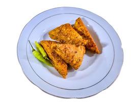 Tempe mendoan Triangular fried tempeh wrapped in wheat flour produces a savory taste photo