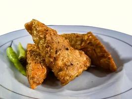 Tempe mendoan Triangular fried tempeh wrapped in wheat flour produces a savory taste photo