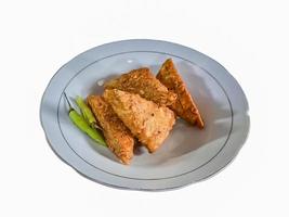 Tempe mendoan Triangular fried tempeh wrapped in wheat flour produces a savory taste photo