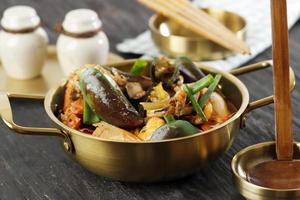 Mix Seafood Soup on Golden  Pan, on Wooden Table photo