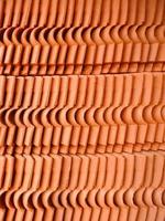 patterned abstract background, made of piles of stone building materials made of red clay photo