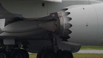 Working aircraft engine close up. The plane stands on the runway, a view of the landing gear and engine video