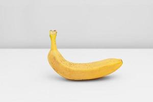 Single yellow ripe banana isolated on white background. Fiber fruits photo