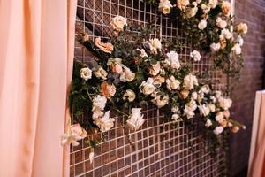 Wedding decor. Photographic area is a stylish wedding decoration. Decorated with flowers, mini florals. Wedding photo zone with flowers. Hand made wedding decorations. Place for taking pictures