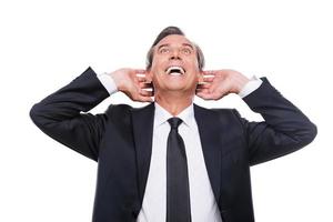 Wow Excited mature man in shirt and tie touching head with hands and looking up with smile while standing isolated on white background photo