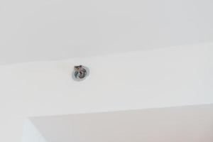 Fire Sprinkler detector mounted on roof in home or apartment. Safety and conflagration security concept photo