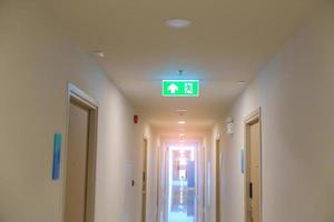 Fire Emergency exit sign on the wall background inside building. Safety concept photo