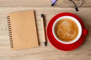 blank notebook and coffee cup on wood table. Motivation, Resolution, To do list, Strategy and Plan concept photo