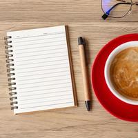 blank notebook and coffee cup on wood table. Motivation, Resolution, To do list, Strategy and Plan concept photo