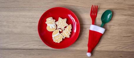 Merry Christmas with homemade cookies, fork and spoon on wood table background. Xmas, party and happy New Year concept photo