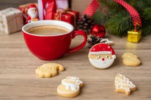 Merry Christmas with homemade cookies and coffee cup on wood table background. Xmas eve, party, holiday and happy New Year concept photo