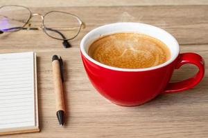 blank notebook and coffee cup on wood table. Motivation, Resolution, To do list, Strategy and Plan concept photo