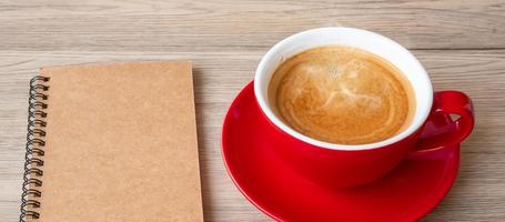 blank notebook and coffee cup on wood table. Motivation, Resolution, To do list, Strategy and Plan concept photo
