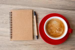 blank notebook and coffee cup on wood table. Motivation, Resolution, To do list, Strategy and Plan concept photo