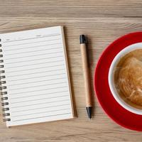 blank notebook and coffee cup on wood table. Motivation, Resolution, To do list, Strategy and Plan concept photo