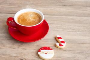 Merry Christmas with homemade cookies and coffee cup on wood table background. Xmas eve, party, holiday and happy New Year concept photo