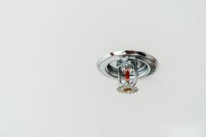 Fire Sprinkler detector mounted on roof in home or apartment. Safety and conflagration security concept photo