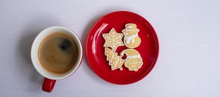 Merry Christmas with homemade cookies and coffee cup on wood table background. Xmas eve, party, holiday and happy New Year concept photo