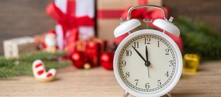 Merry Christmas with Vintage alarm clock and Xmas decoration on wooden table. party, holiday and boxing day concept photo