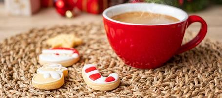 Merry Christmas with homemade cookies and coffee cup on wood table background. Xmas eve, party, holiday and happy New Year concept photo