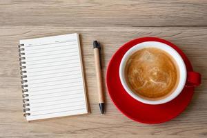 blank notebook and coffee cup on wood table. Motivation, Resolution, To do list, Strategy and Plan concept photo
