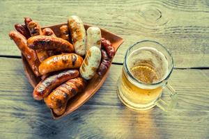 salchichas a la parrilla con cerveza foto