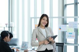 Portrait of an Asian female rookie in the new entrepreneurial team in the business photo