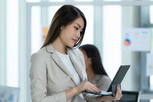 Portrait of an Asian female rookie in the new entrepreneurial team in the business photo