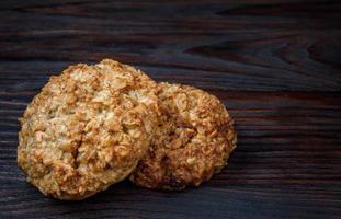 Oatmeal cookies lie on a wooden surface. Rustic oatmeal cookies. photo