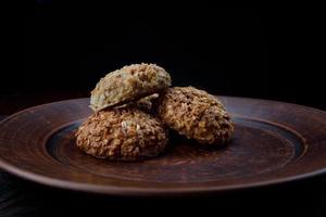 Oatmeal cookies lie on a clay plate. Rustic oatmeal cookies. photo