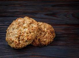 Oatmeal cookies lie on a wooden surface. Village cookies. photo
