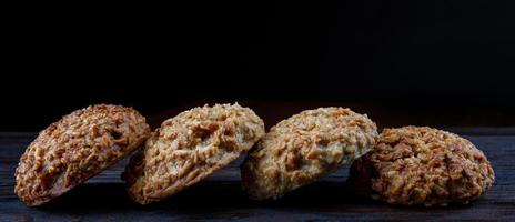 Oatmeal cookies laid out in a row on a wooden board. Rustic oatmeal cookies. photo