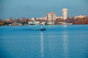 Fishermen on a boat on the river catch fish in autumn. Fishing is a special kind of sport. photo