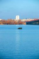 Fishermen on a boat on the river catch fish in autumn. Fishing is a special kind of sport. photo