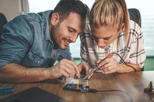 Engineers Soldering Electronic Circuit Board photo