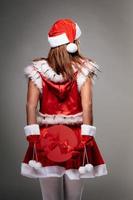 Female Santa Claus With Christmas Present photo