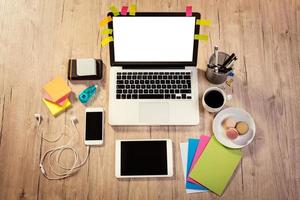 Workspace With Coffee Cup And French Macaroons photo