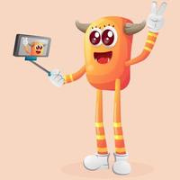 Cute orange monster takes a selfie with smartphone vector