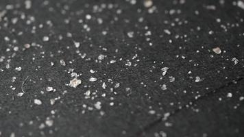 White flakes on black fabric video