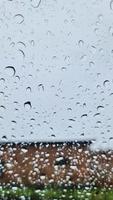 Rain drops running down a car window in a close up view. video