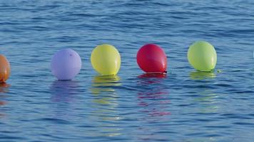 Funny Colorful Balloons Swimming on the Sea Water video