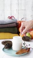 High angle view autumn composition with sweaters and candles, white candle mockup design video